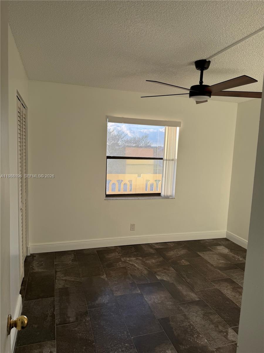 9355 Southwest 8th Street, Unit 305 Boca Raton, FL 33428 - Photo 6 of 12 an empty room with wooden floor and windows