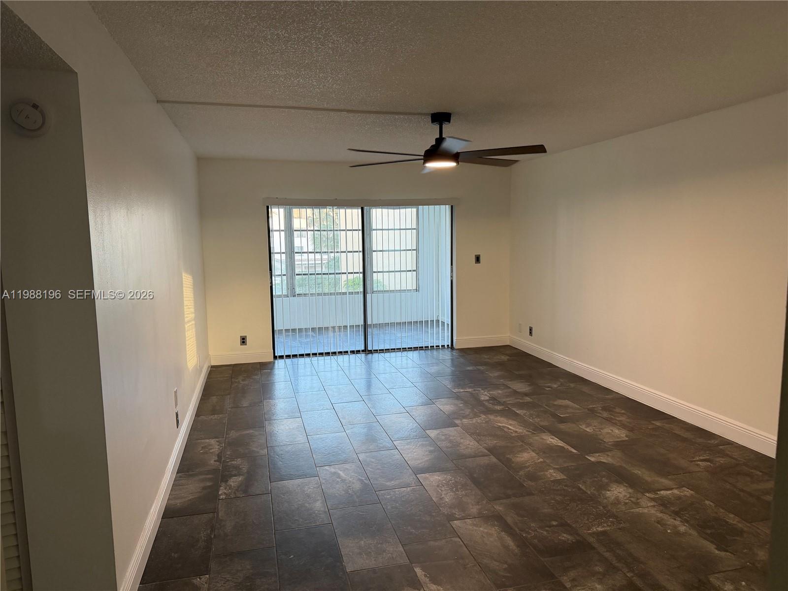 9355 Southwest 8th Street, Unit 305 Boca Raton, FL 33428 - Photo 9 of 12 en empty room with windows and ceiling fan