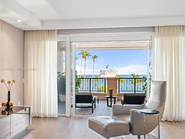 a balcony with furniture and a potted plant