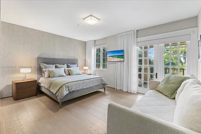 a view of a patio with couches table and chairs under an umbrella