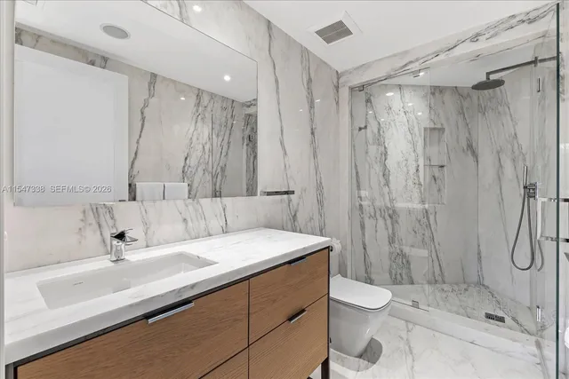 a view of a patio with table and chairs under an umbrella