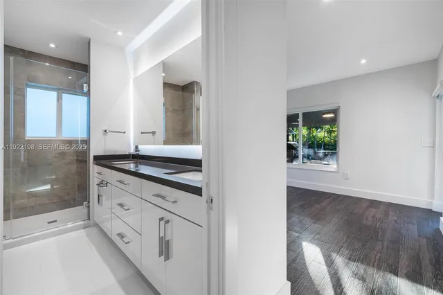 a bathroom with a double vanity sink and mirror