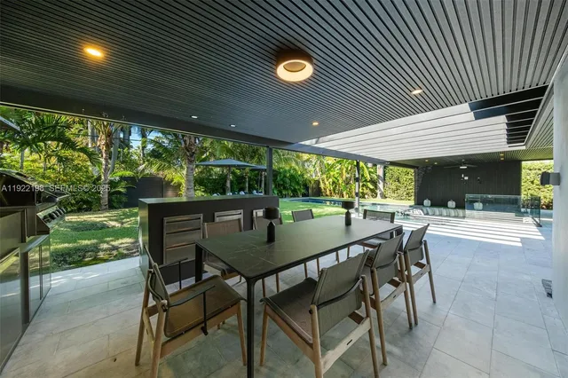 a view of a patio with a table and chairs