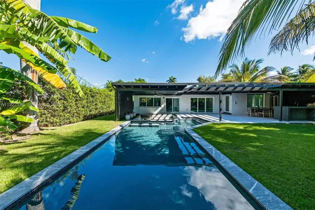 a patio with table and chairs under an umbrella