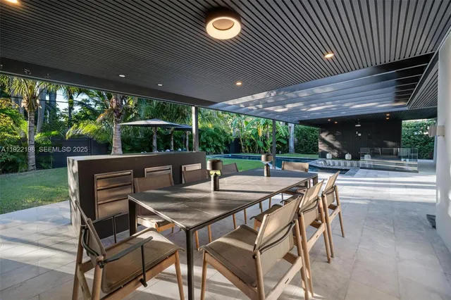 a view of a patio with a table and chairs
