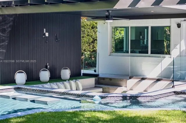 a kitchen that has a lot of white cabinets and wooden floor