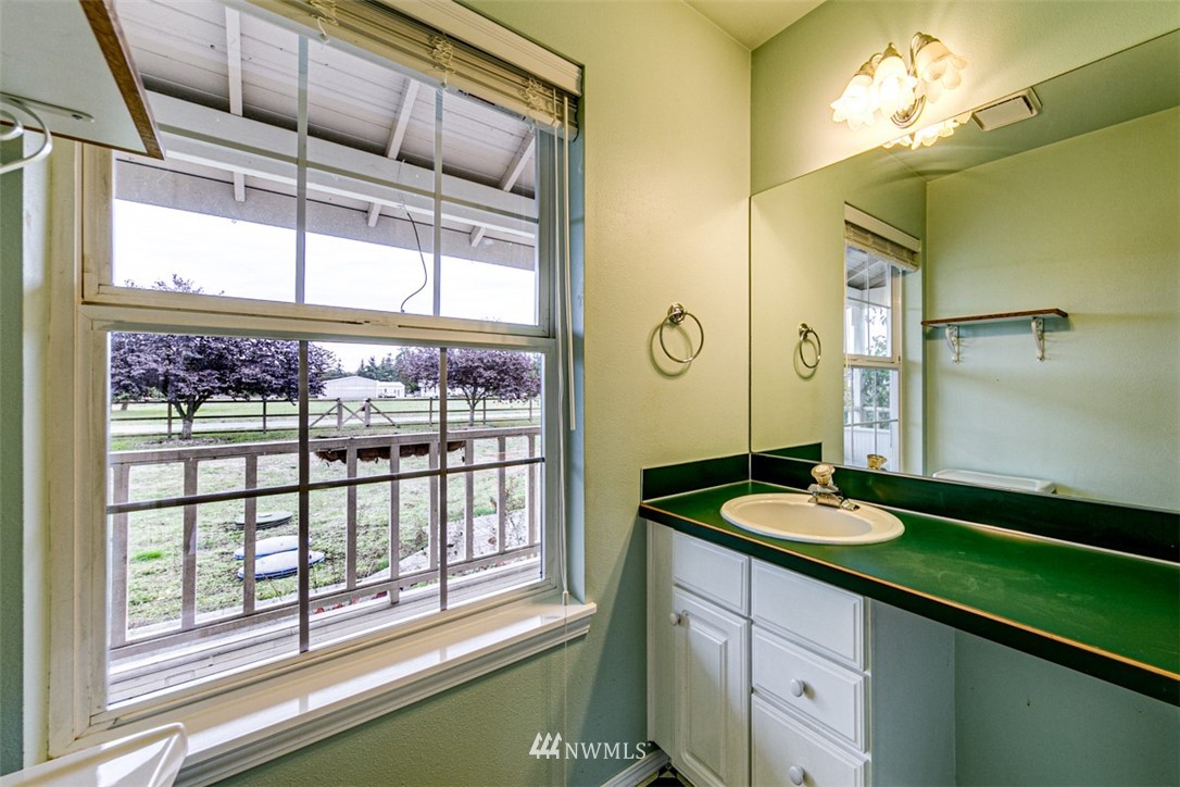 243 Griffith Farm Road Sequim, WA 98382 - Photo 11 of 35 a bathroom with a sink and a large mirror