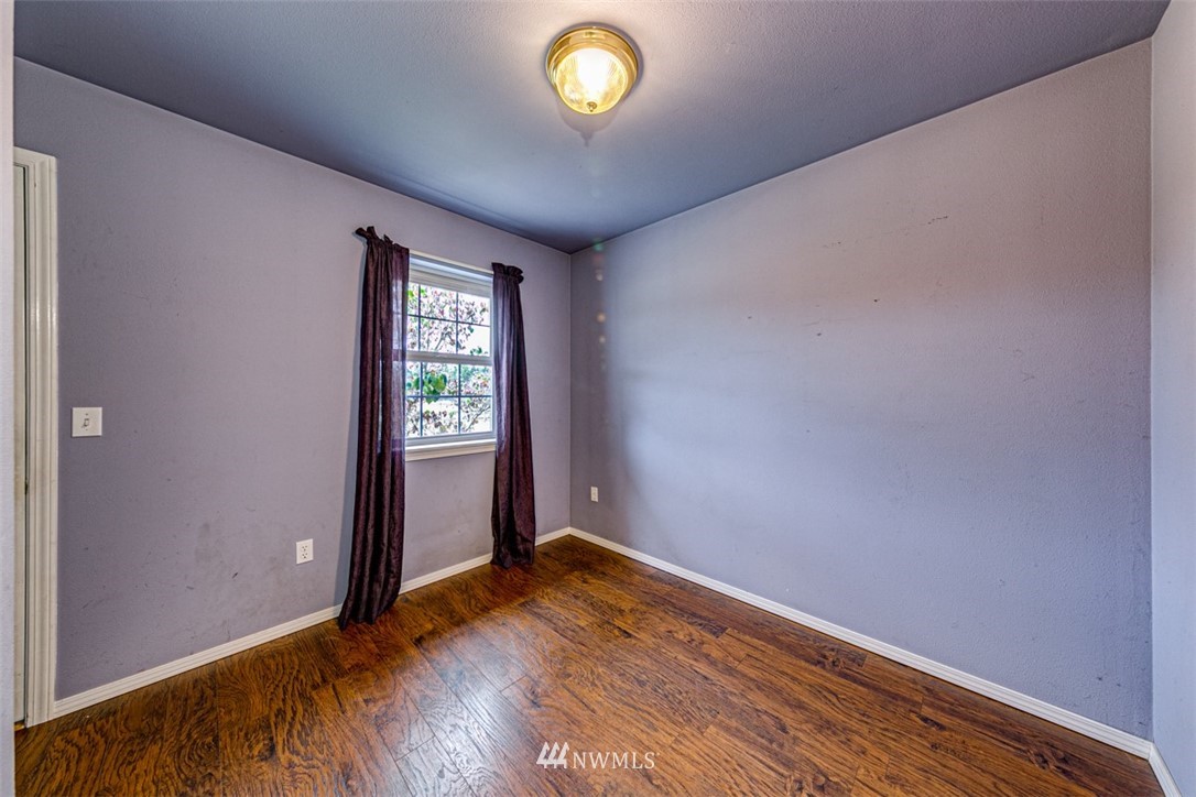 243 Griffith Farm Road Sequim, WA 98382 - Photo 12 of 35 a view of an empty room with a window and wooden floor