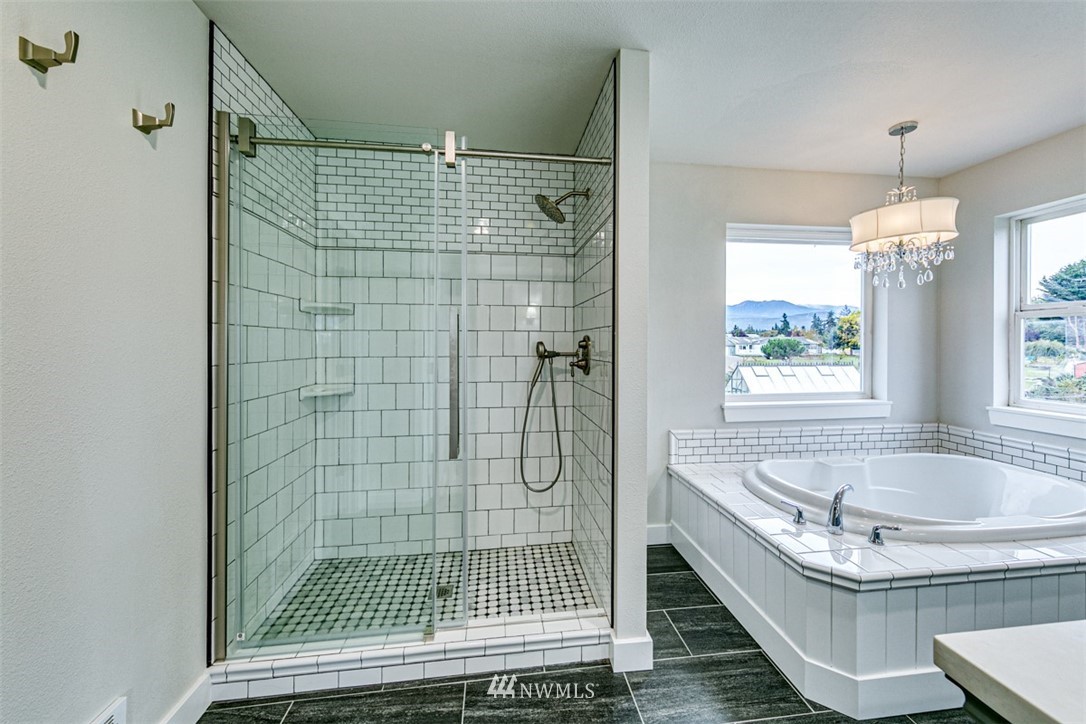 243 Griffith Farm Road Sequim, WA 98382 - Photo 25 of 35 a bathroom with a tub a sink and window