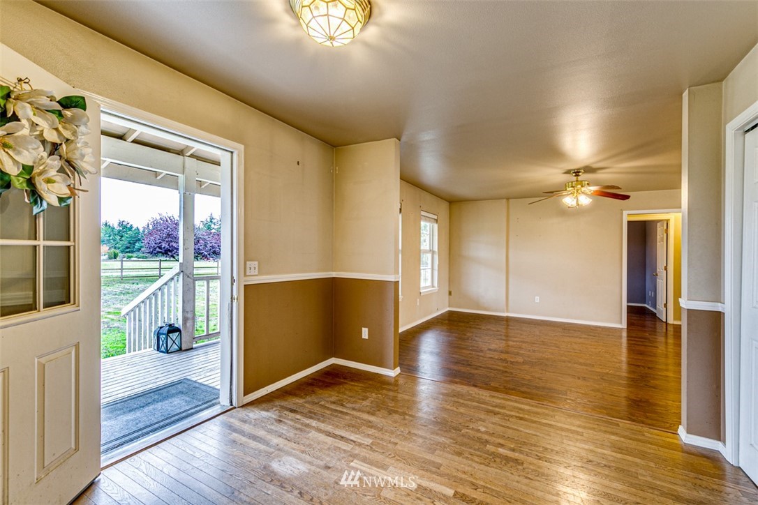 243 Griffith Farm Road Sequim, WA 98382 - Photo 4 of 35 a view of an empty room with wooden floor and a window