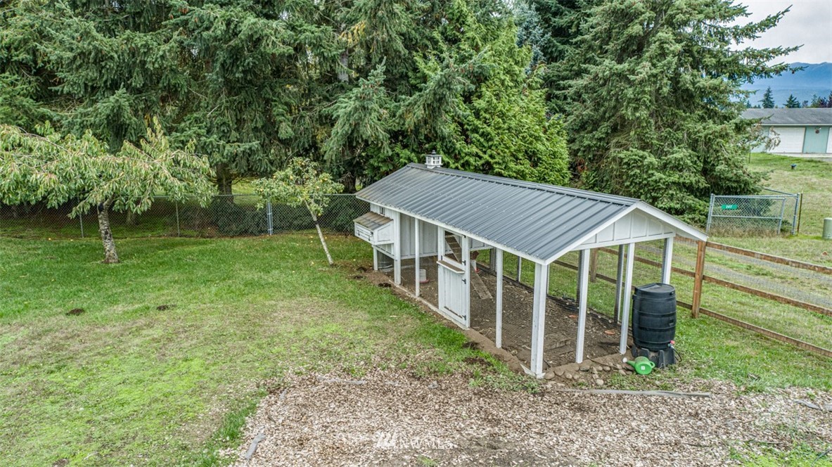 243 Griffith Farm Road Sequim, WA 98382 - Photo 33 of 35 a backyard of a house with table and chairs