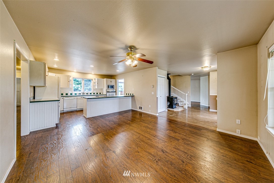 243 Griffith Farm Road Sequim, WA 98382 - Photo 5 of 35 a view of a big room with wooden floor and a kitchen