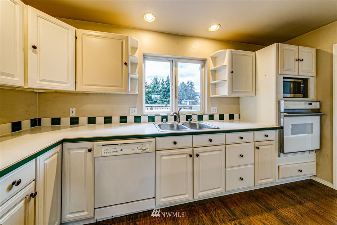 243 Griffith Farm Road Sequim, WA 98382 - Photo 6 of 35 a kitchen with granite countertop white cabinets white appliances and sink