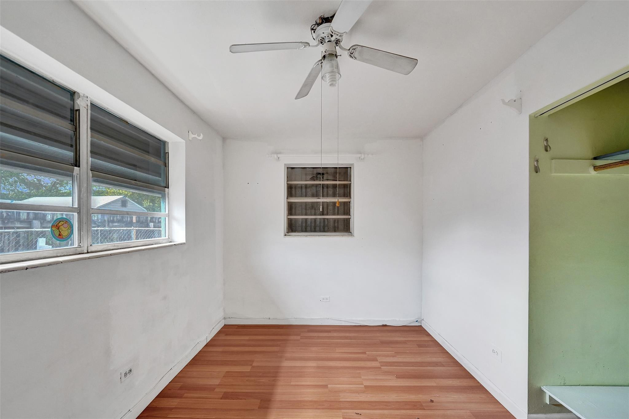 1960 Southwest 68th Way Miramar, FL 33023 - Photo 13 of 39 a view of an empty room with a window and wooden floor