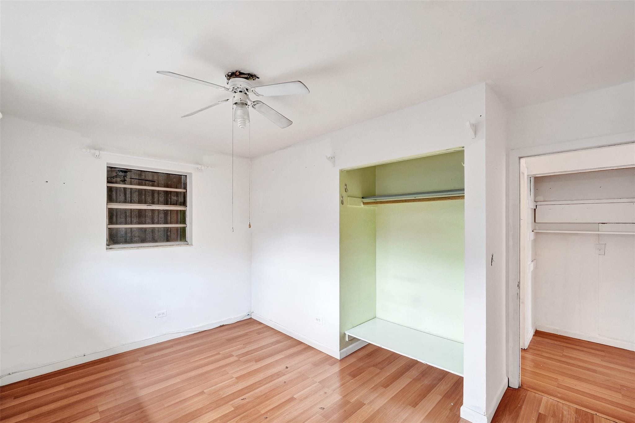 1960 Southwest 68th Way Miramar, FL 33023 - Photo 14 of 39 a view of an empty room with wooden floor and a ceiling fan