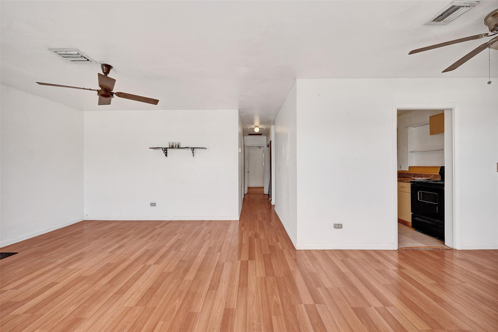 1960 Southwest 68th Way Miramar, FL 33023 - Photo 2 of 39 a view of a room with wooden floor staircase and a hallway