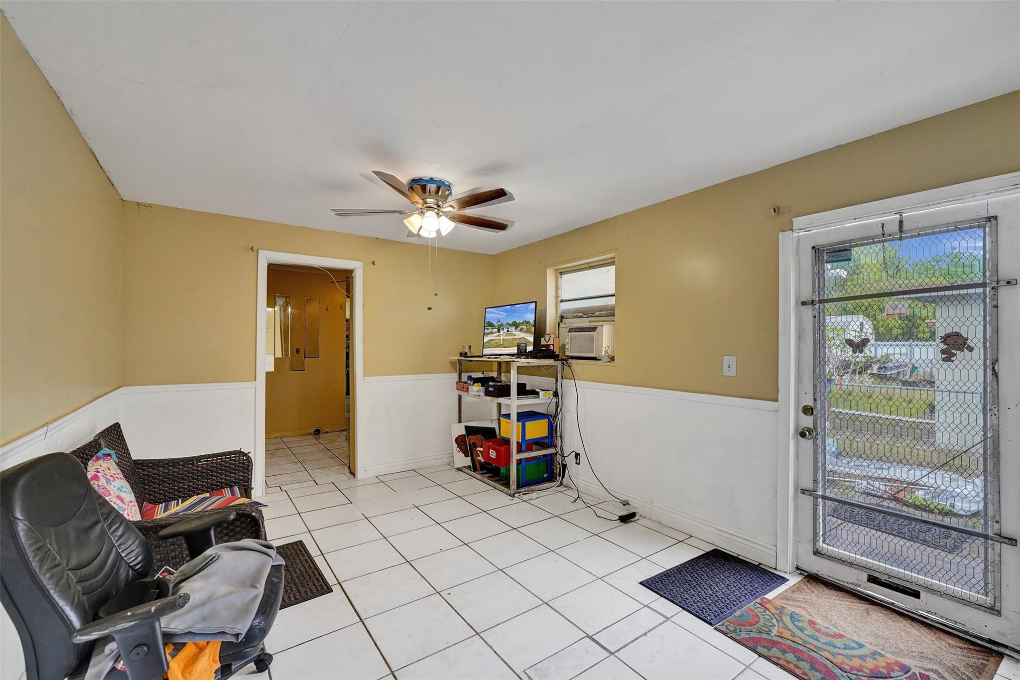 1960 Southwest 68th Way Miramar, FL 33023 - Photo 23 of 39 a view of a livingroom with furniture and a flat screen tv