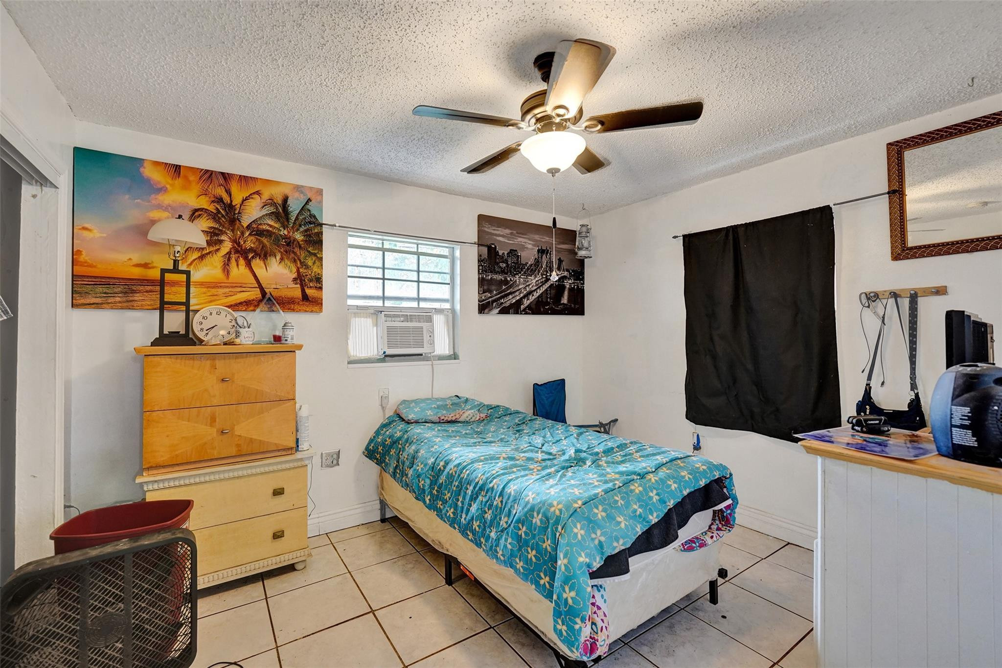 1960 Southwest 68th Way Miramar, FL 33023 - Photo 31 of 39 a bedroom with a bed and a painting on the wall