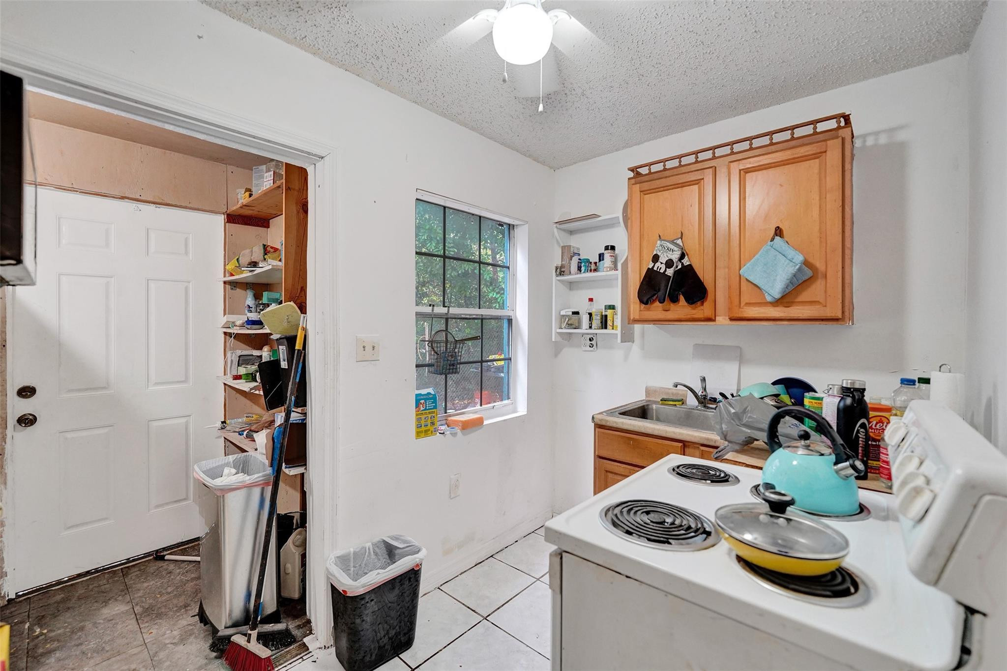 1960 Southwest 68th Way Miramar, FL 33023 - Photo 33 of 39 a kitchen with stainless steel appliances granite countertop a stove and a sink with cabinets