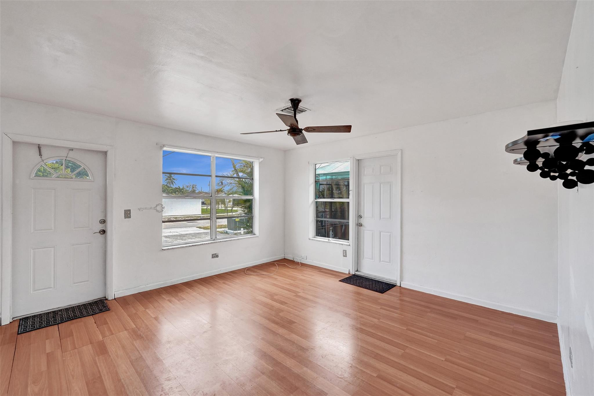 1960 Southwest 68th Way Miramar, FL 33023 - Photo 5 of 39 a view of an empty room with wooden floor and a window