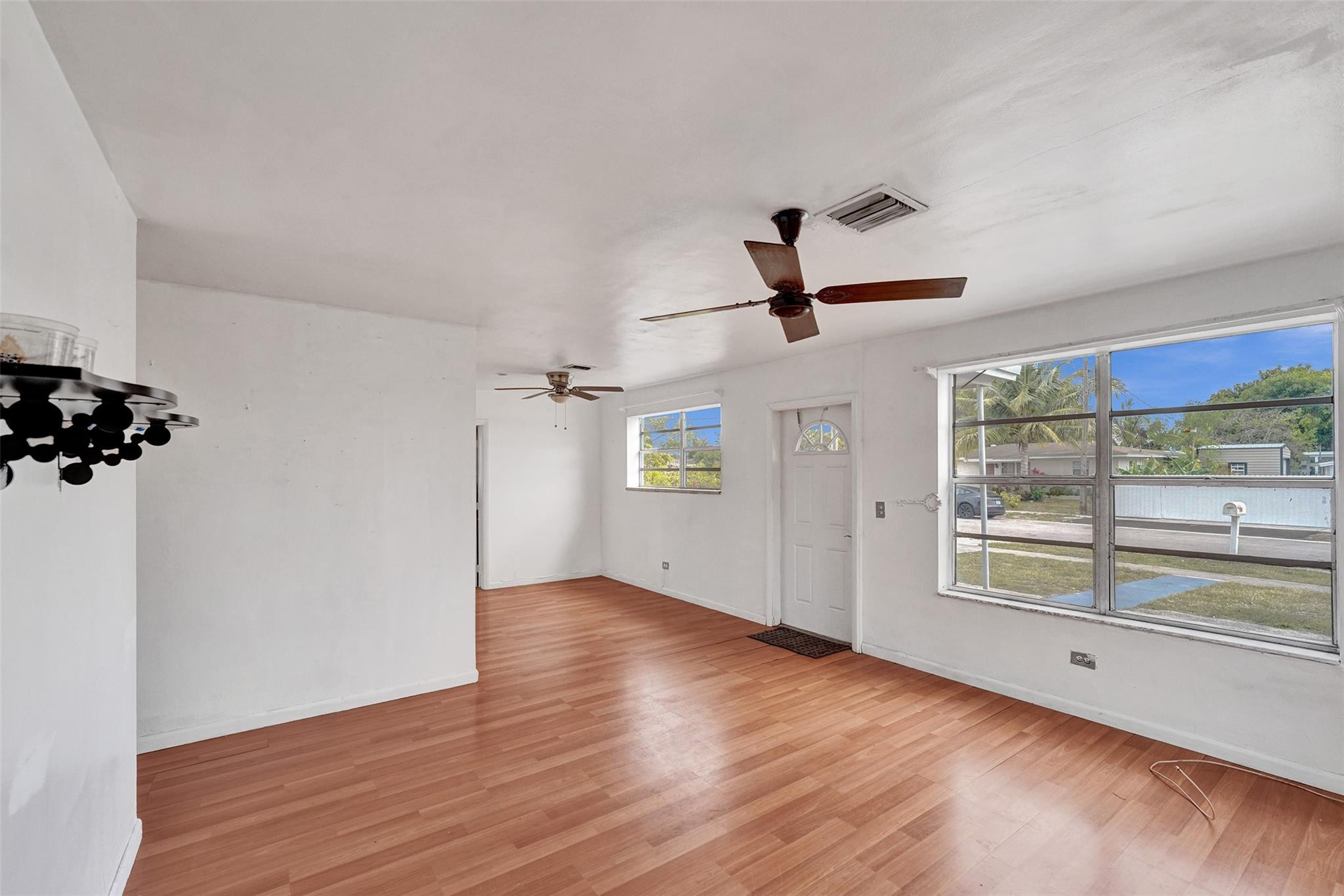 1960 Southwest 68th Way Miramar, FL 33023 - Photo 6 of 39 wooden floor in an empty room with a window