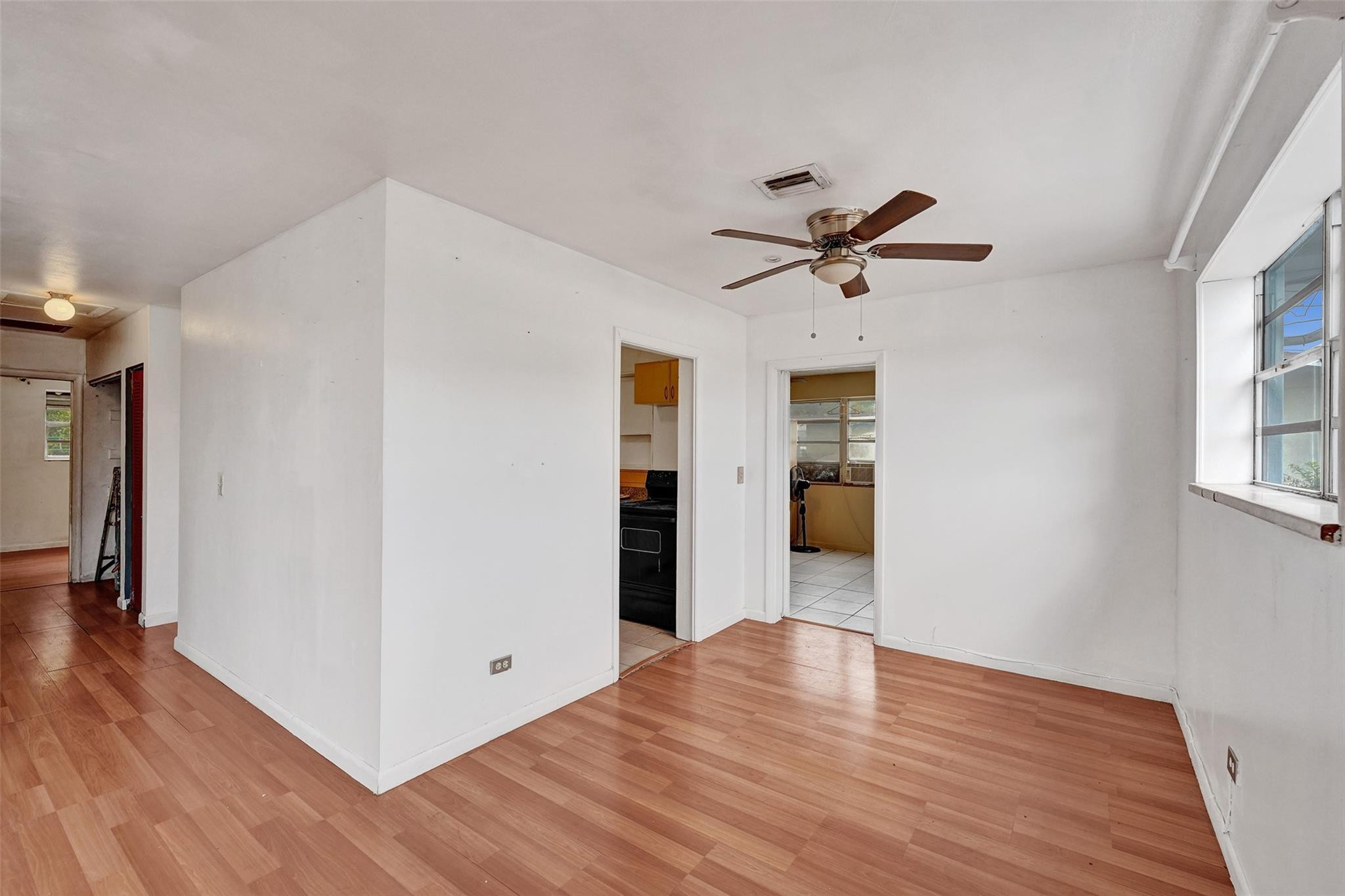 1960 Southwest 68th Way Miramar, FL 33023 - Photo 8 of 39 a view of a workspace with wooden floor and a ceiling fan