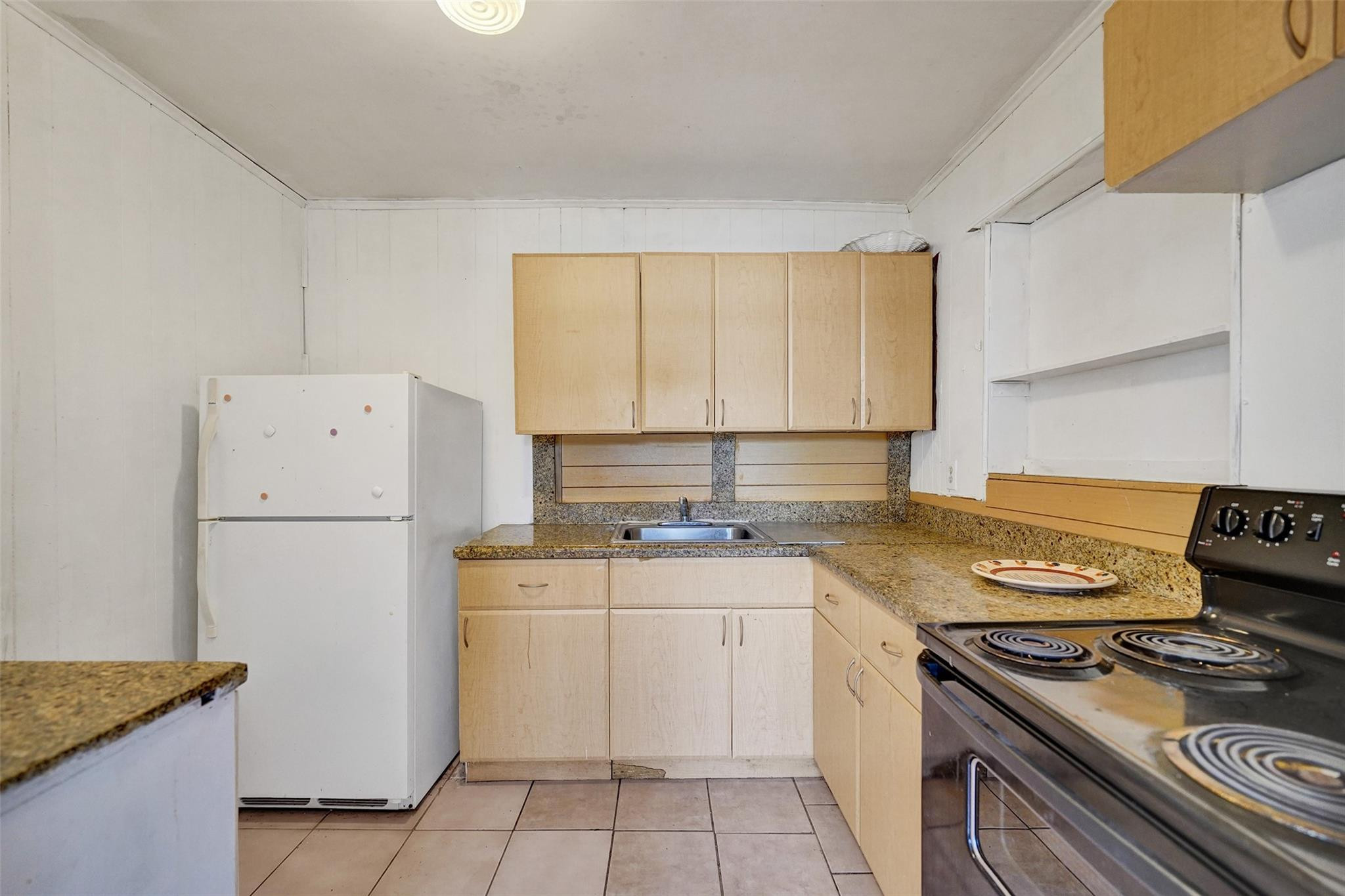 1960 Southwest 68th Way Miramar, FL 33023 - Photo 9 of 39 a kitchen with a stove a sink and a refrigerator