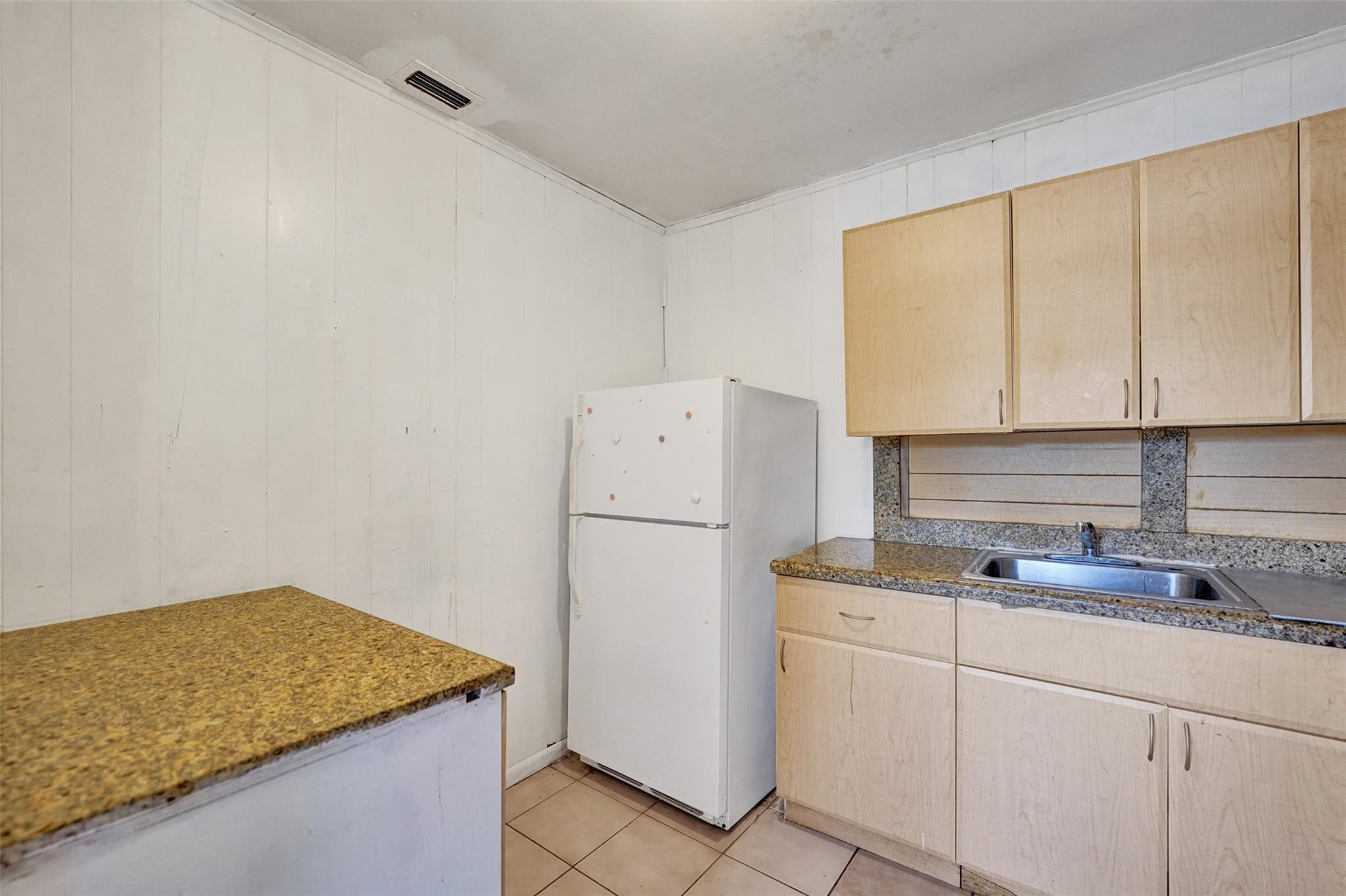 1960 Southwest 68th Way Miramar, FL 33023 - Photo 10 of 39 a kitchen with a sink cabinets and refrigerator
