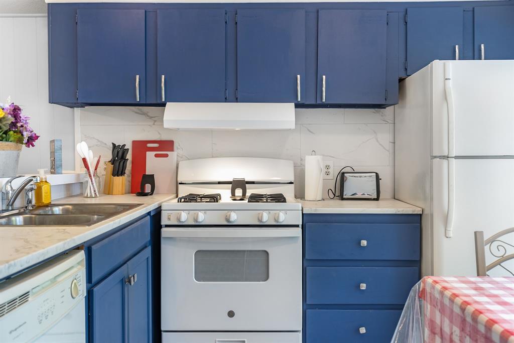277 Private Road Pittsburg, TX 75686 - Photo 14 of 40 a kitchen with a sink a stove and cabinets