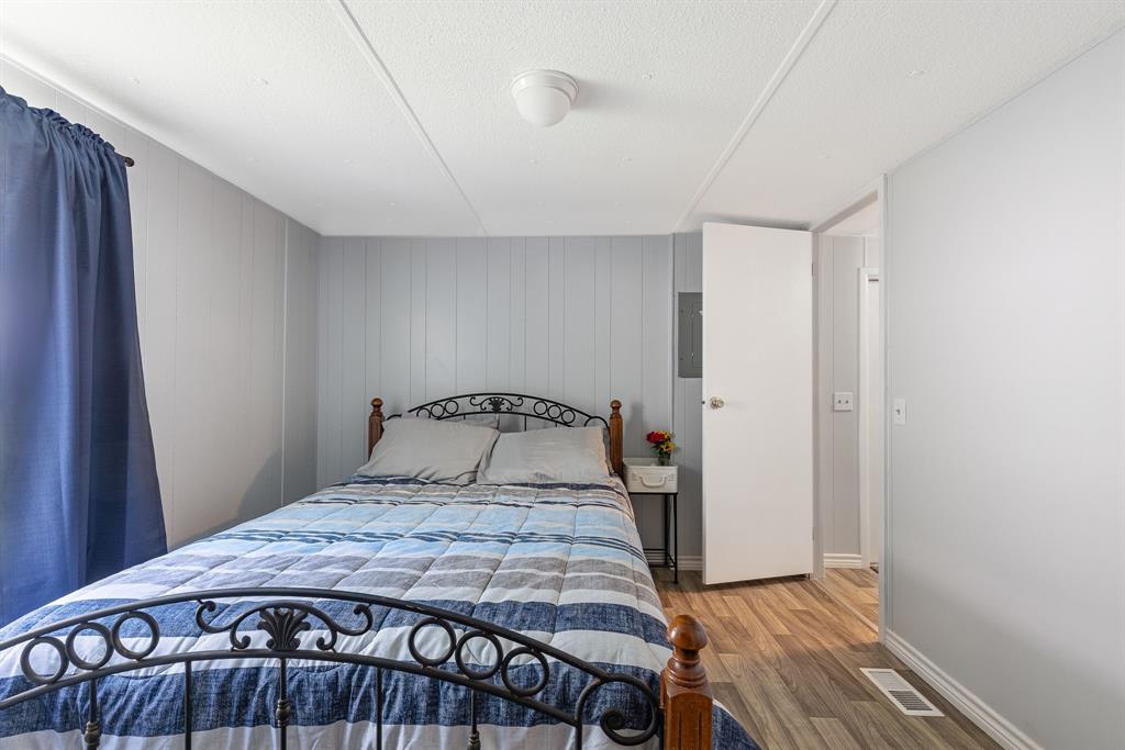 277 Private Road Pittsburg, TX 75686 - Photo 19 of 40 a bedroom with a bed and wooden floor