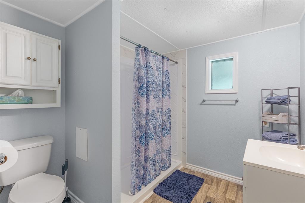 277 Private Road Pittsburg, TX 75686 - Photo 20 of 40 a bathroom with a toilet a sink and shower