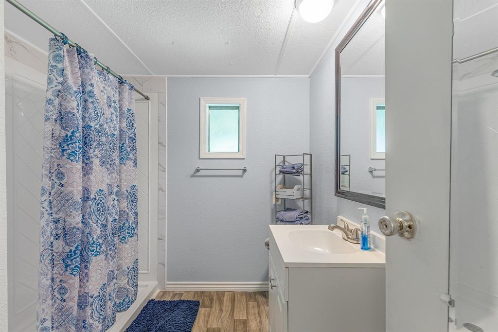 277 Private Road Pittsburg, TX 75686 - Photo 21 of 40 a bathroom with a sink a toilet and shower