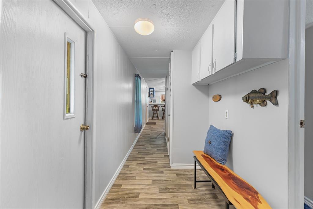 277 Private Road Pittsburg, TX 75686 - Photo 22 of 40 a view of a hallway with wooden floor and staircase