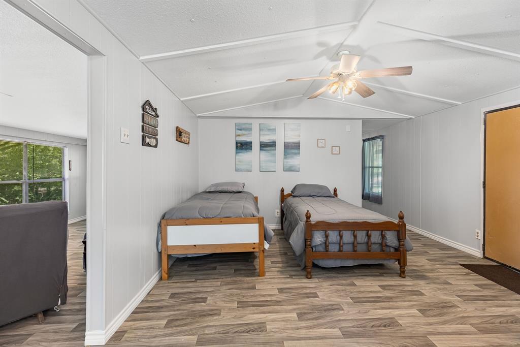 277 Private Road Pittsburg, TX 75686 - Photo 25 of 40 a bedroom with two beds and a chandelier