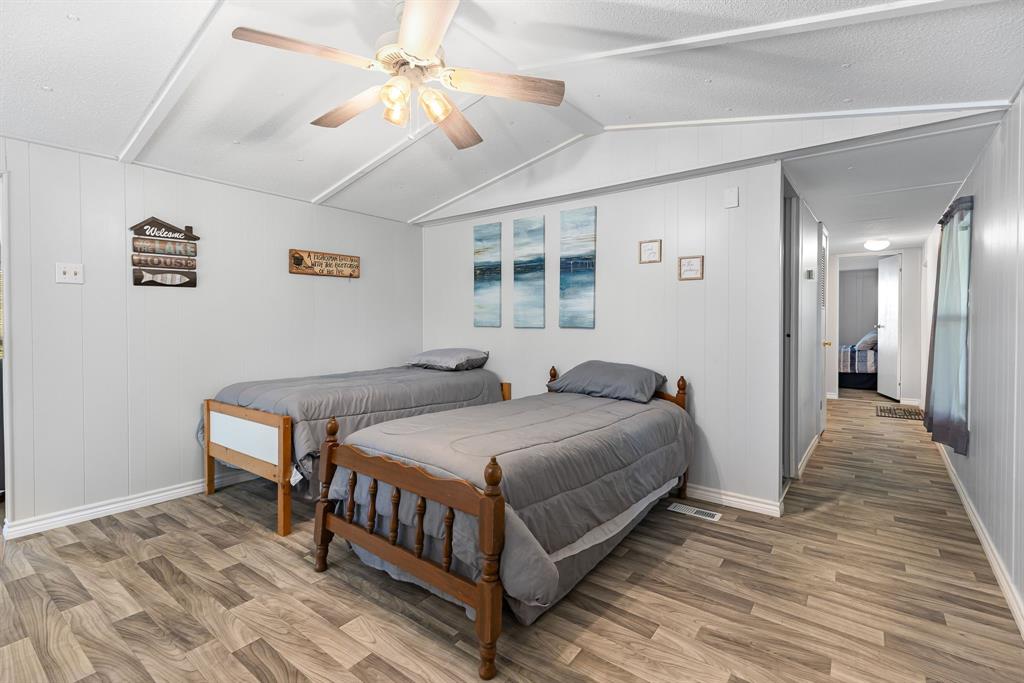 277 Private Road Pittsburg, TX 75686 - Photo 26 of 40 a bedroom with a bed and a chandelier