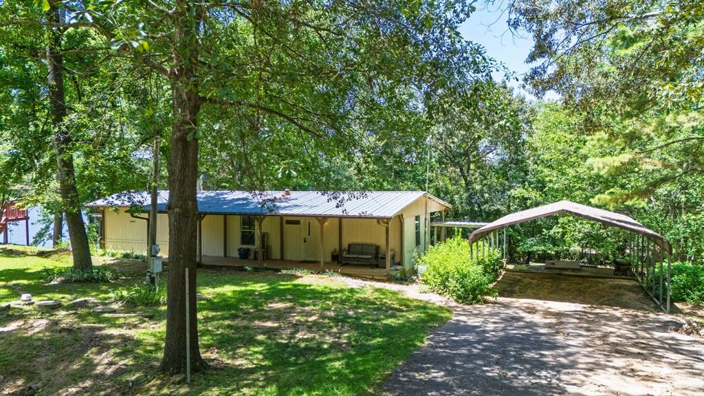 277 Private Road Pittsburg, TX 75686 - Photo 3 of 40 a front view of a house with garden