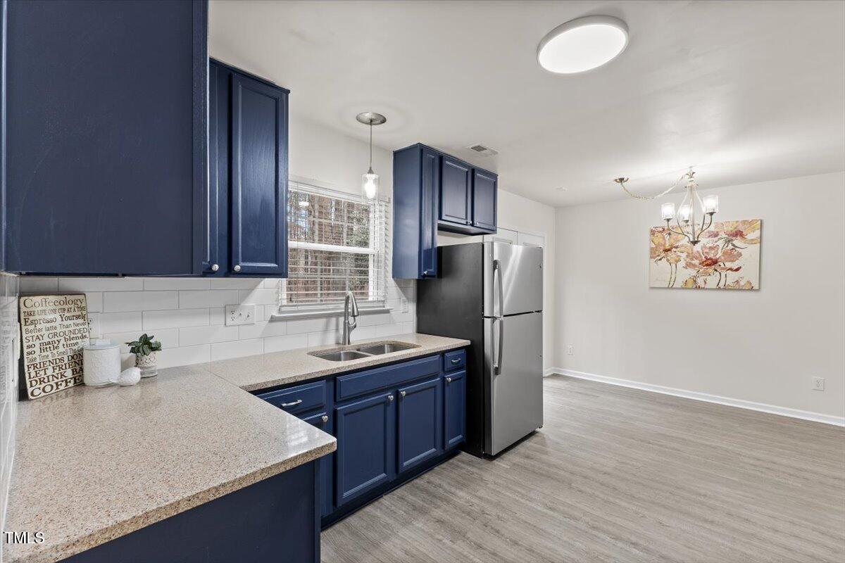 315 Inkster Cove Raleigh, NC 27603 - Photo 12 of 44 a kitchen with stainless steel appliances granite countertop a sink stove and refrigerator
