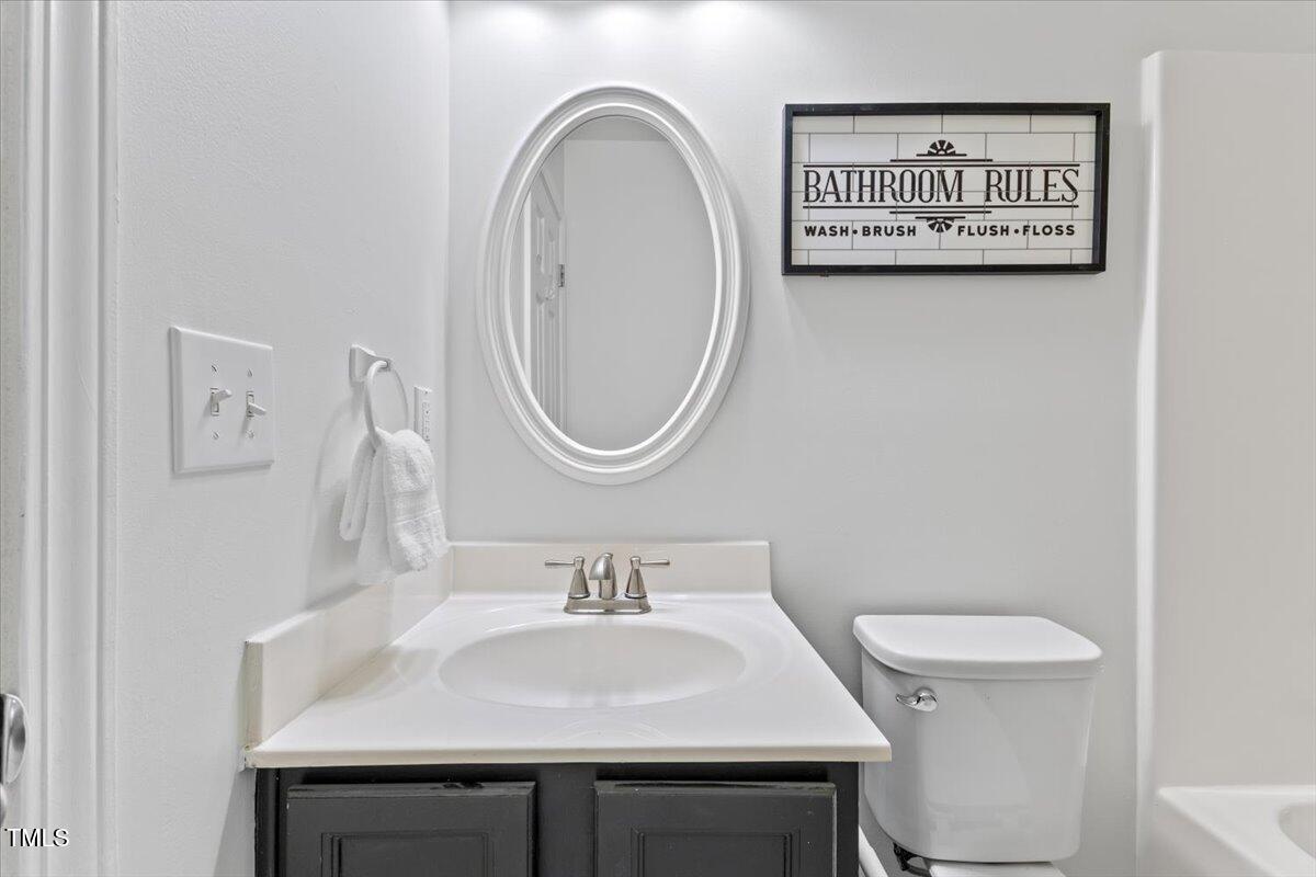 315 Inkster Cove Raleigh, NC 27603 - Photo 27 of 44 a bathroom with a sink a toilet and a mirror
