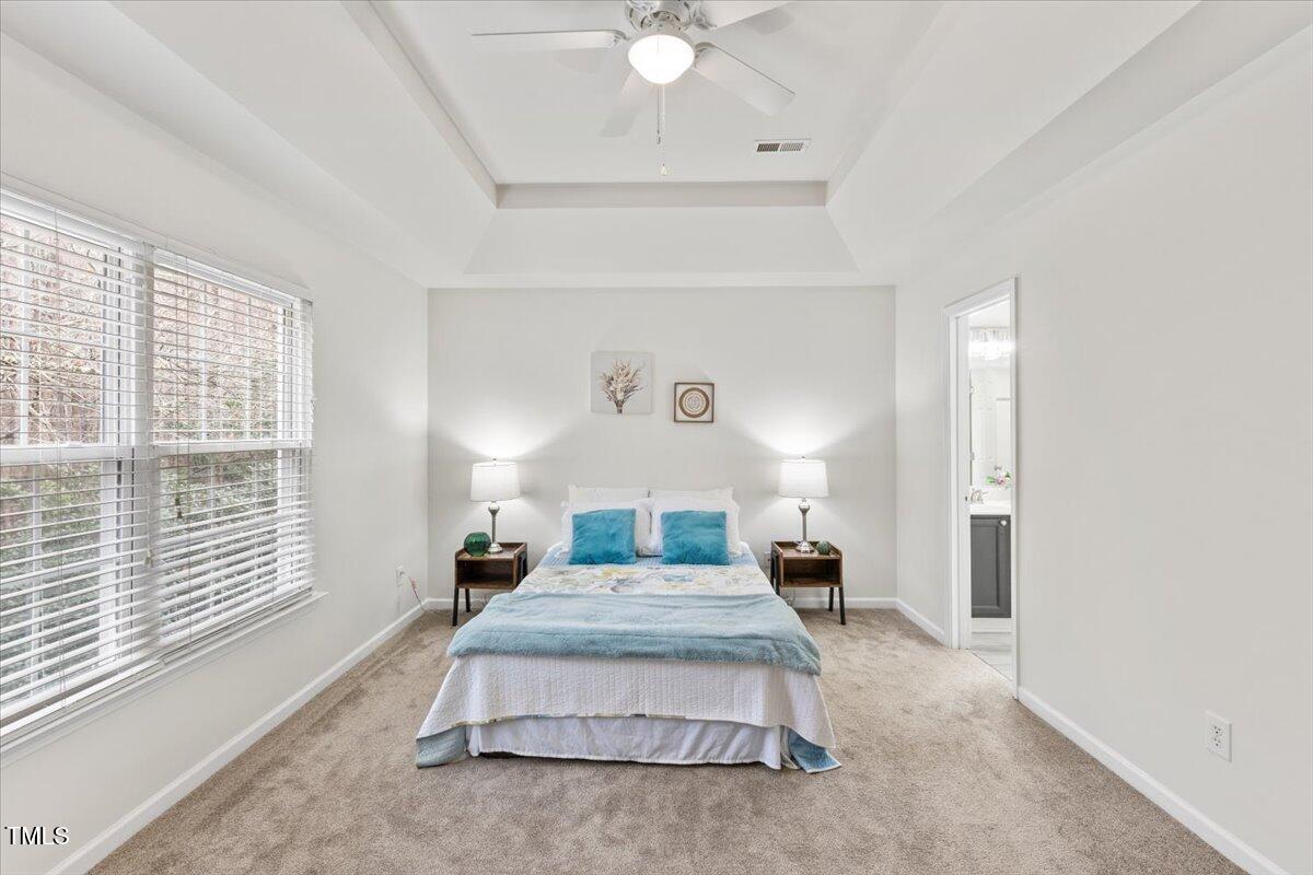 315 Inkster Cove Raleigh, NC 27603 - Photo 31 of 44 a bedroom with a large bed and a large window