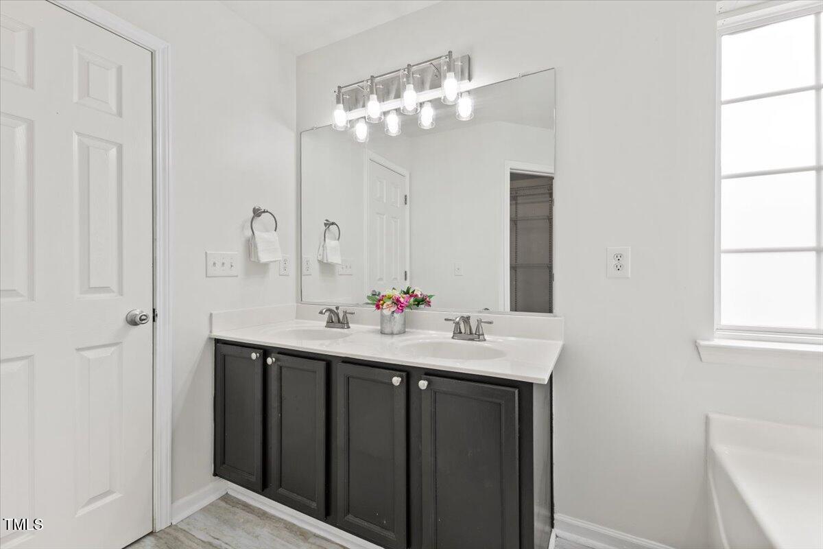 315 Inkster Cove Raleigh, NC 27603 - Photo 33 of 44 a bathroom with a sink and a mirror