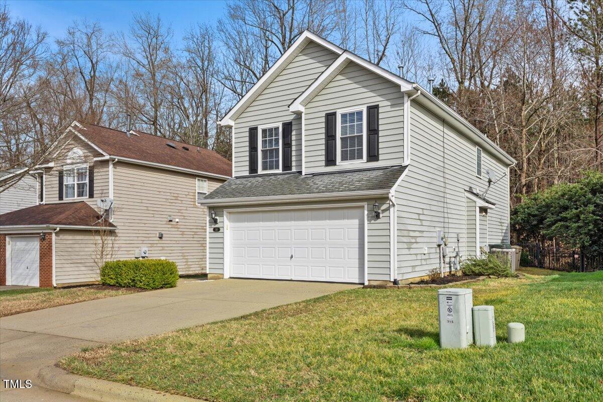 315 Inkster Cove Raleigh, NC 27603 - Photo 4 of 44 a front view of a house with a yard and garage