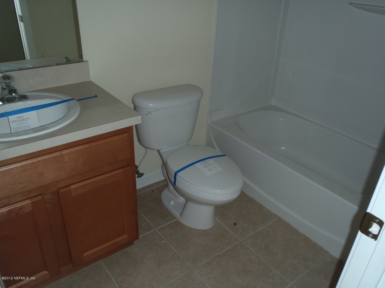 6700 Bowden Road, Unit 302 Jacksonville, FL 32216 - Photo 3 of 11 a white toilet sitting next to a bathroom sink