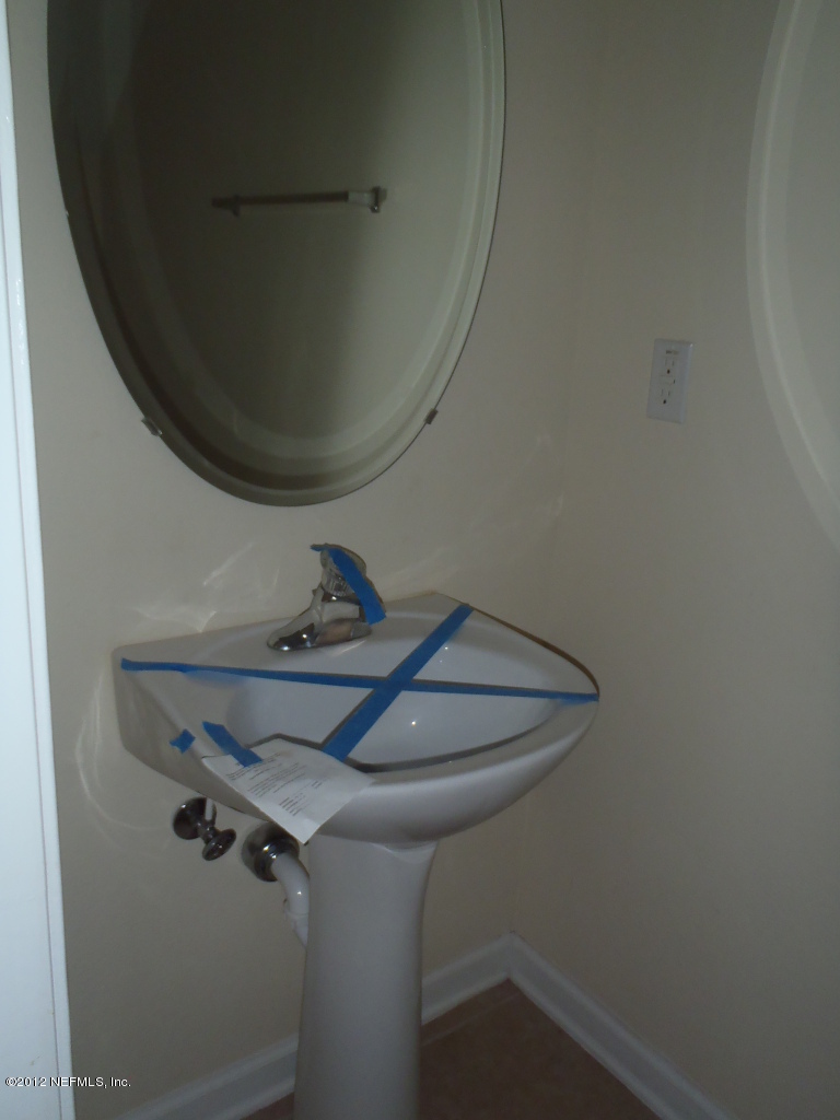 6700 Bowden Road, Unit 302 Jacksonville, FL 32216 - Photo 7 of 11 a bathroom with a sink and mirror
