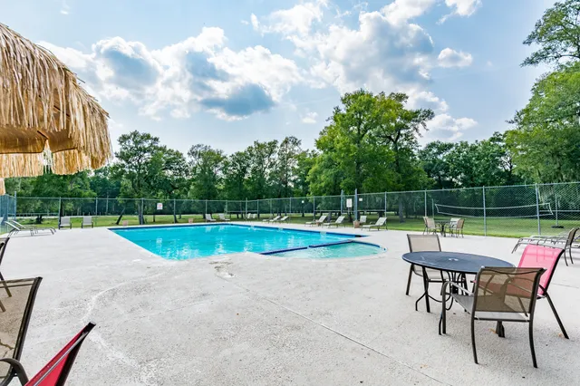 a view of swimming pool with chairs