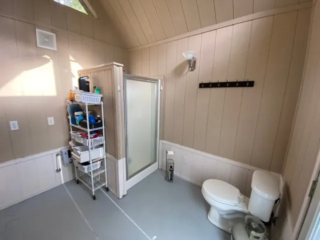 a bathroom with a sink toilet and shower