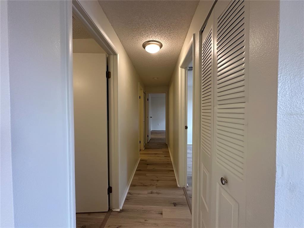 4022 Beaver Lane, Unit 1000H Port Charlotte, FL 33952 - Photo 11 of 24 a view of a hallway with wooden floor