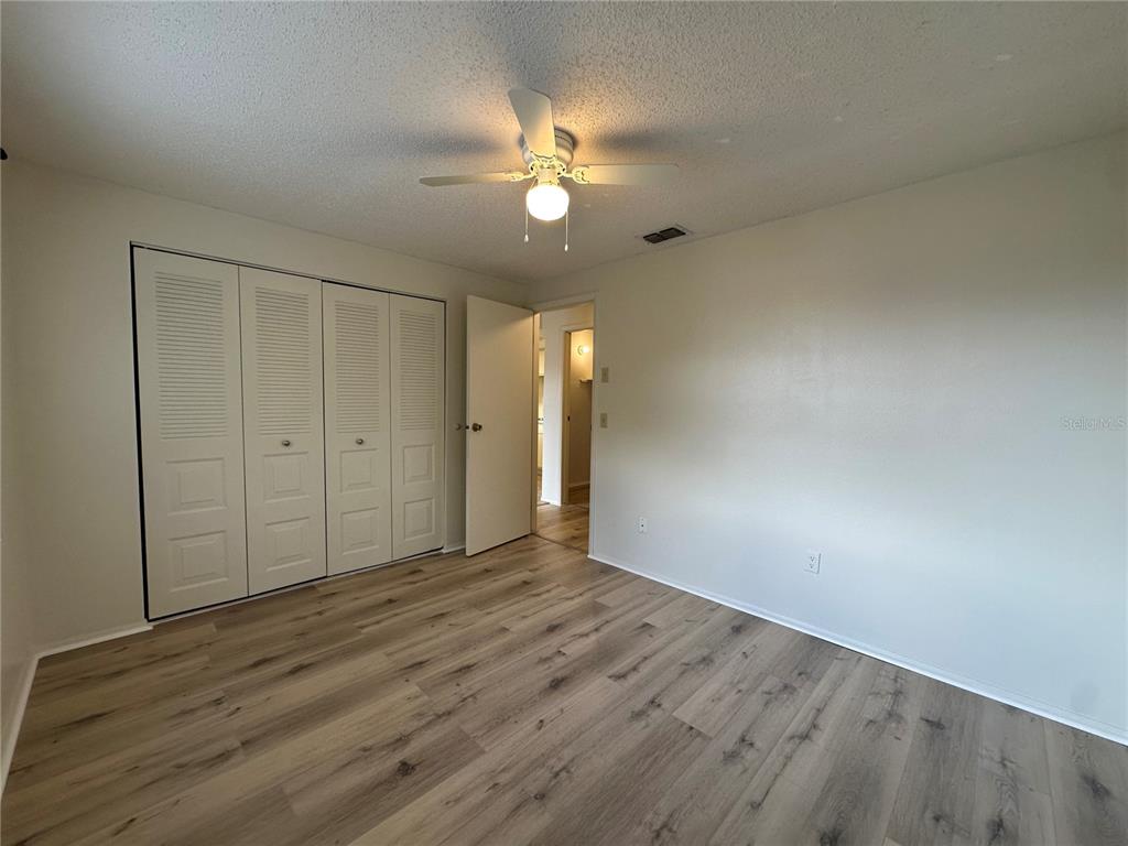 4022 Beaver Lane, Unit 1000H Port Charlotte, FL 33952 - Photo 18 of 24 a view of an empty room with wooden floor