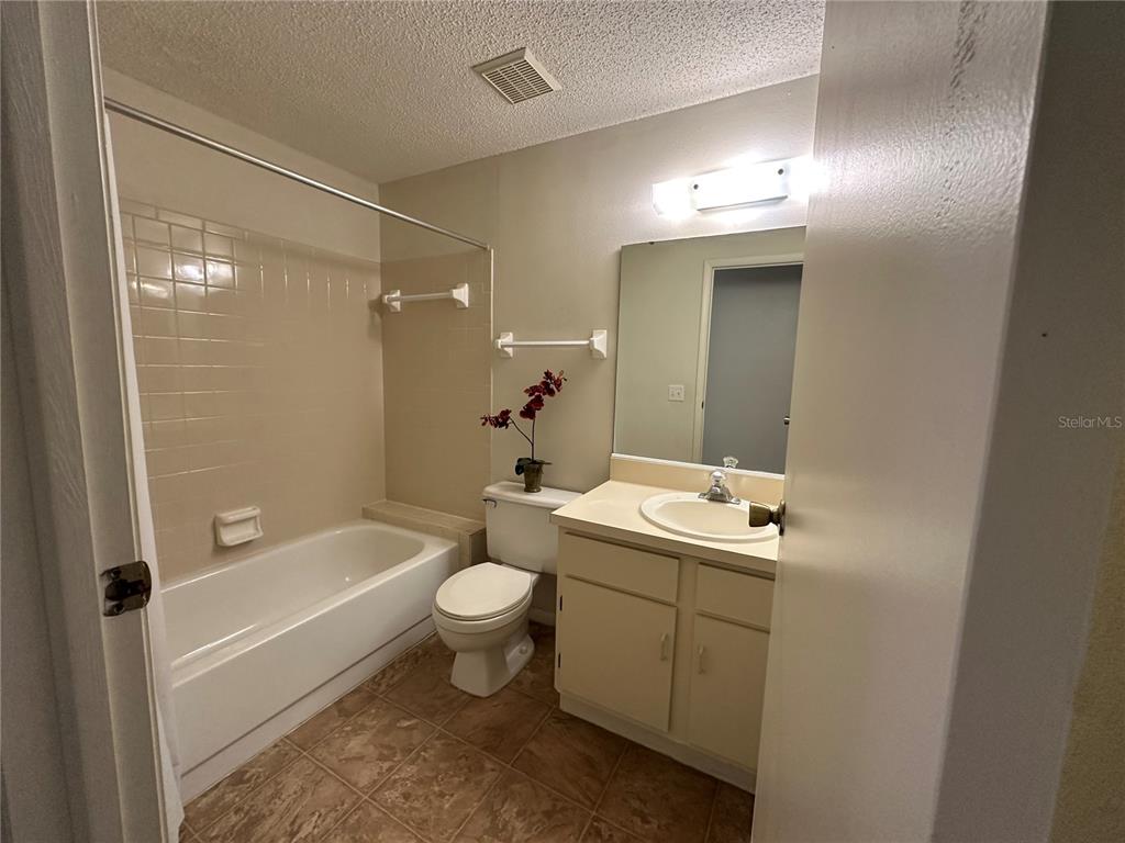 4022 Beaver Lane, Unit 1000H Port Charlotte, FL 33952 - Photo 19 of 24 a bathroom with a sink mirror toilet and bathtub