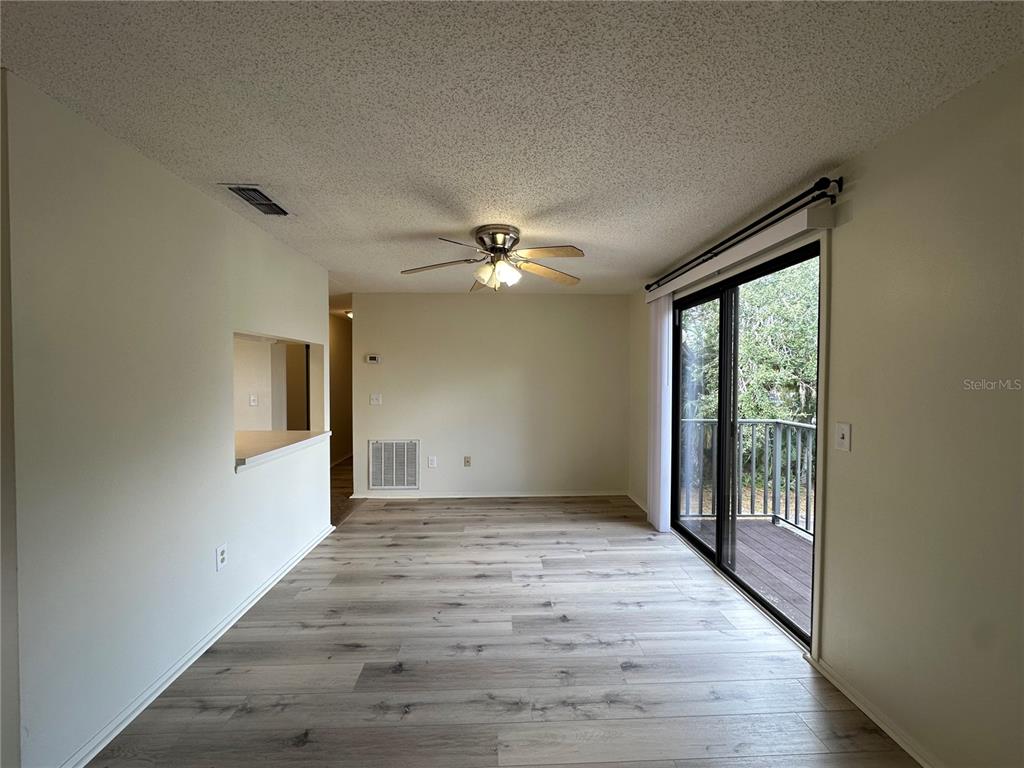 4022 Beaver Lane, Unit 1000H Port Charlotte, FL 33952 - Photo 6 of 24 a view of a livingroom with a ceiling fan and window