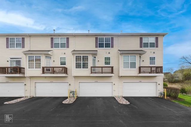 a living room with couches and kitchen view